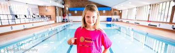 Isla Davis wearing a Brain Tumour Research t-shirt at the swimming pool