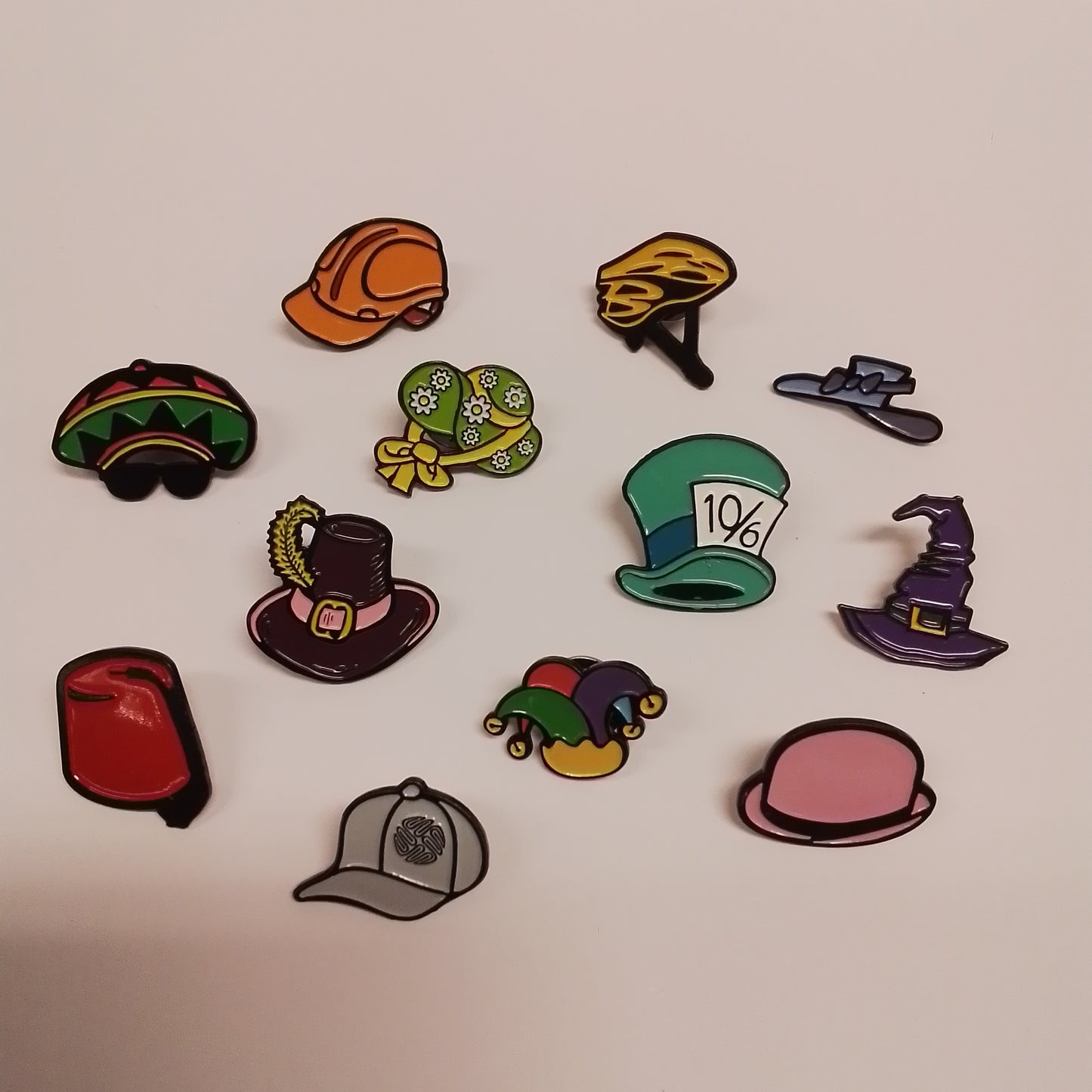WAHD24 pin badges - mixed box of 24 - Style B - Contents: 2 x each of: Ascot 2016. Builder. Cyclist. Easter Bonnet. Fez. Grey baseball cap. Guy Fawkes. Jester.Mad Hatter. Pink Bowler. Rasta. Wizard