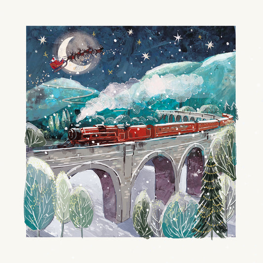 Red steam train crossing a snowy viaduct beneath a starry sky, while Santa’s sleigh flies past the moon overhead.